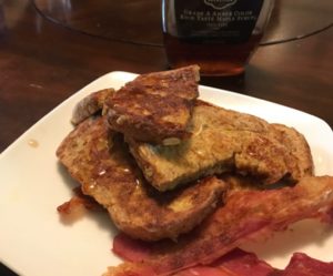Honey Oats and Flax French Toast with Maple Syrup and a side of bacon.