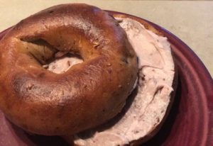 Strawberry cream Cheese with the Cinnamon Raisin Remix bagel. eating bread