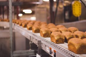 Fresh baked bread waiting to be sliced on a solar powered line.